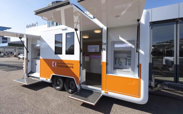 Kantonal Bank mobile branch trailer with external ATMs and interior custom service areas